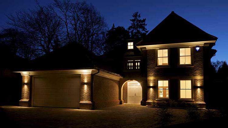 Home with indoor and outdoor lights on.